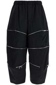 comme des garcons black cropped pants with zip openings.